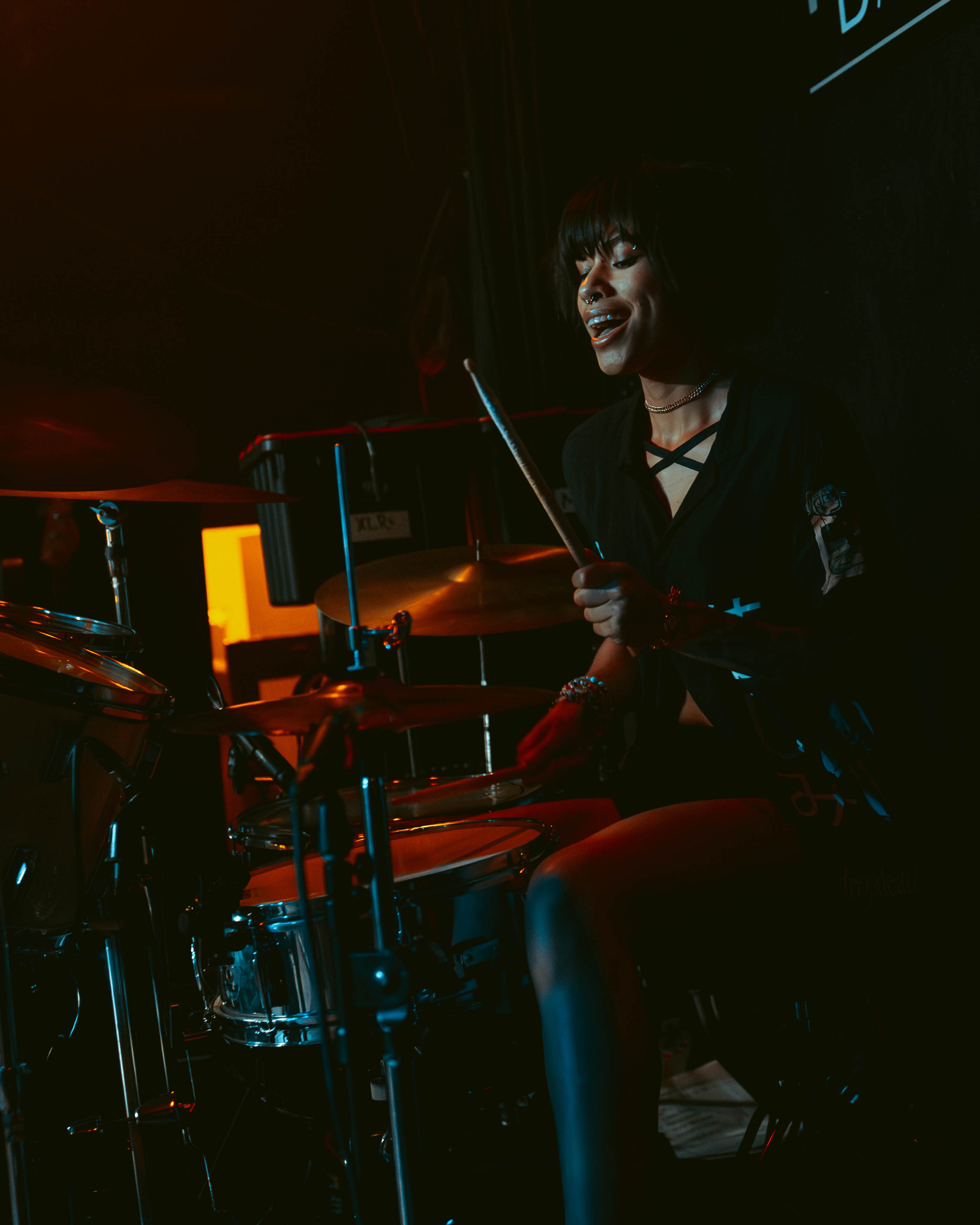 Bite Marks drummer performing under red stage lighting